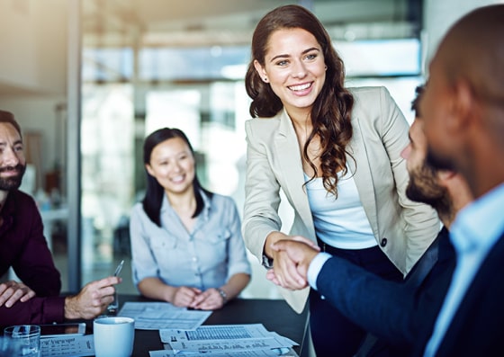 key steps in developing a business plan Smiling woman shaking hands