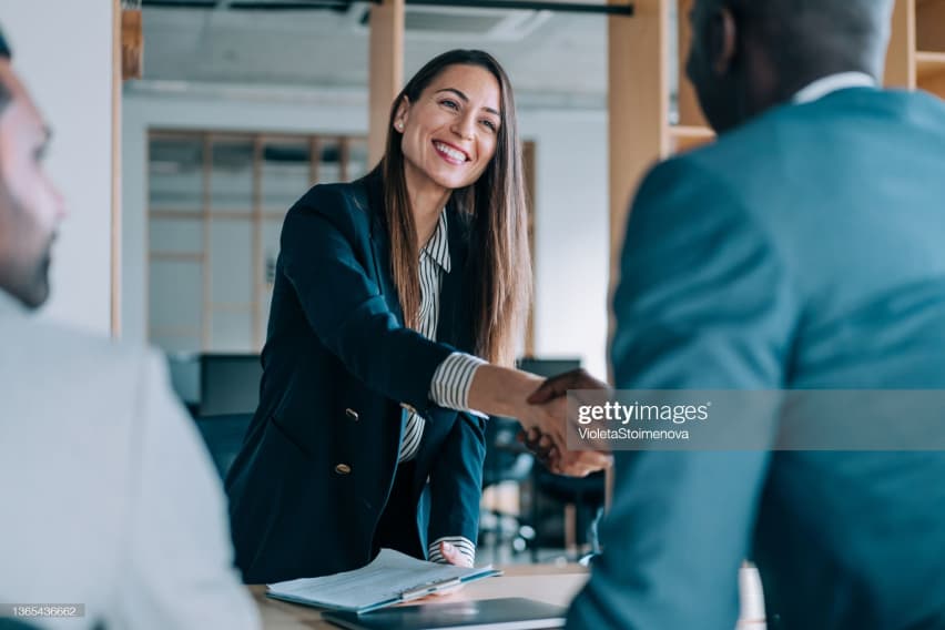 Smiling woman shaking hands